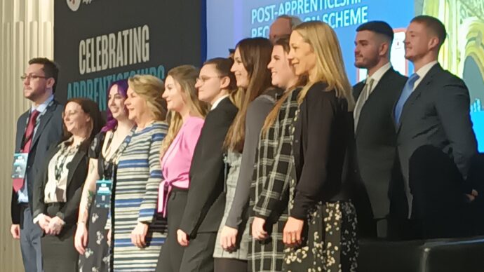 Cohort of apprentices on stage